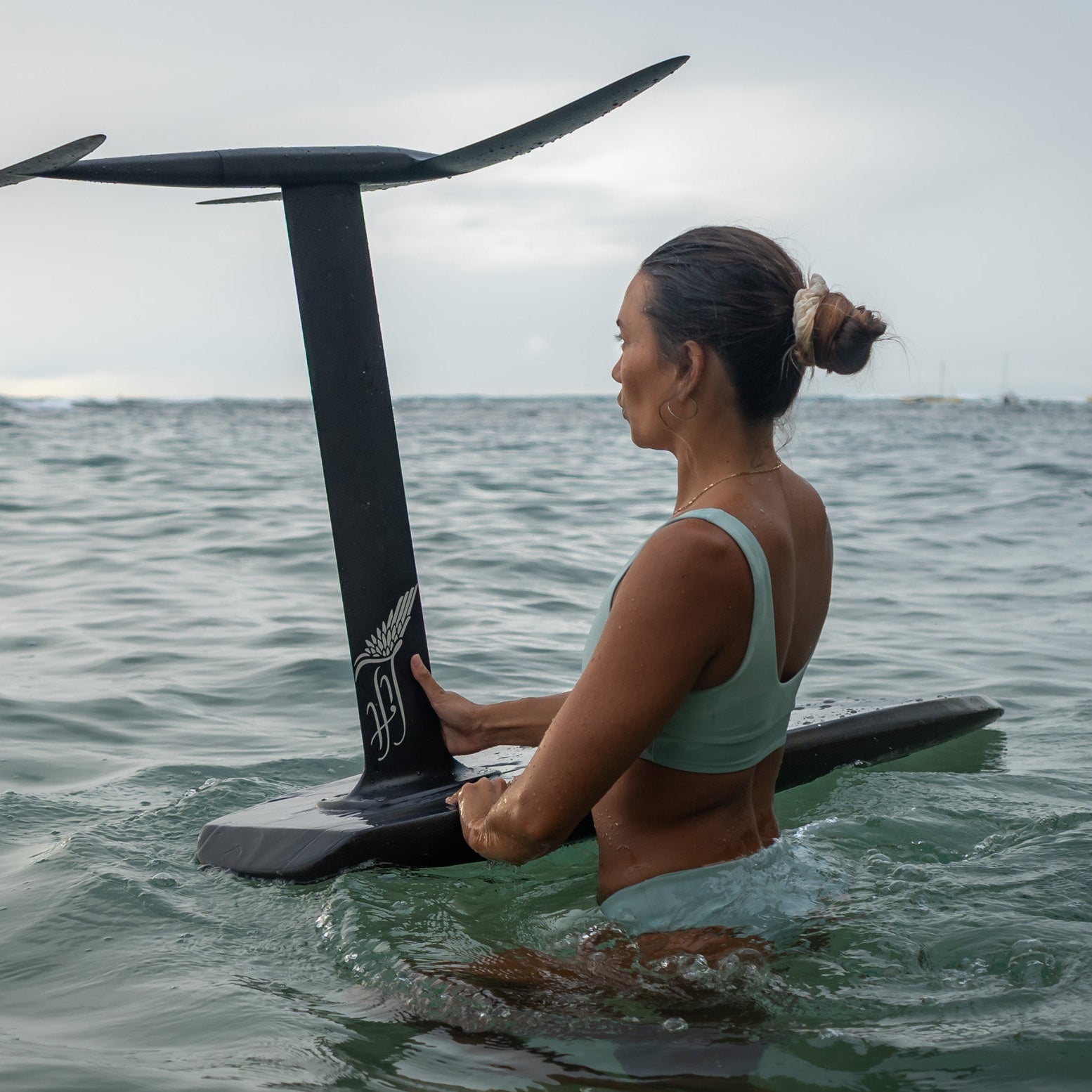 A women holding a hydrofoil in the water