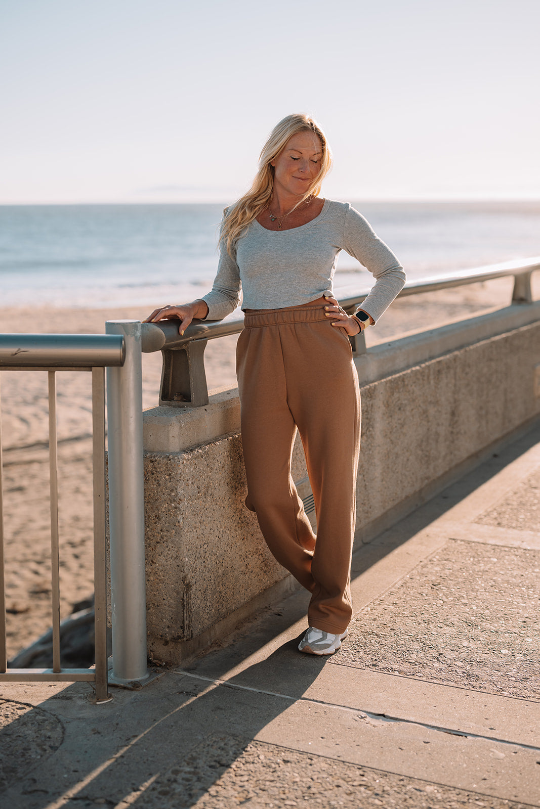 Woman standing on a pathway by the beach with ocean view
