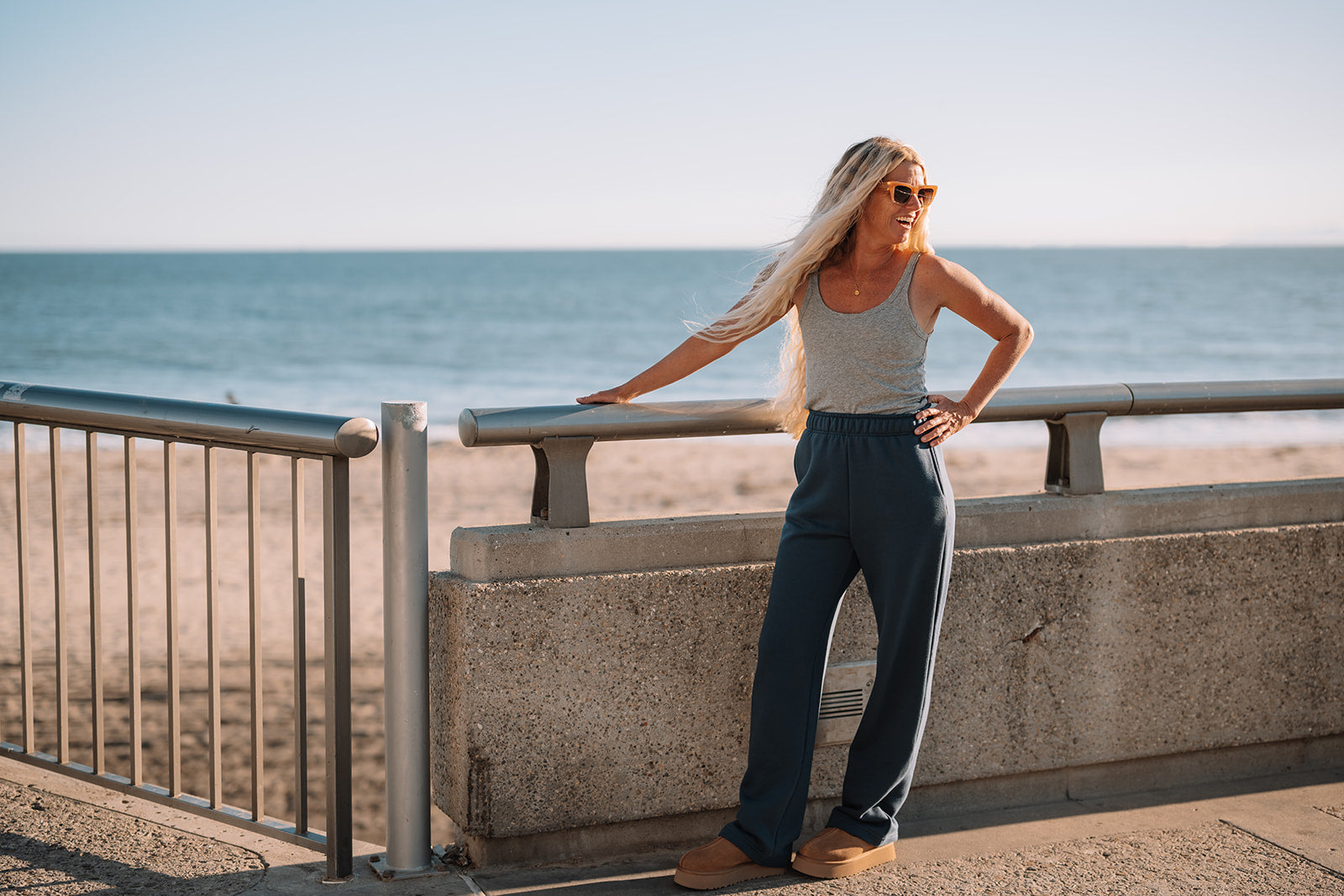 Woman standing by a railing with an ocean view
