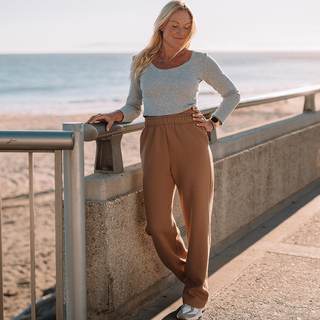 Woman standing on a pathway by the beach with ocean view