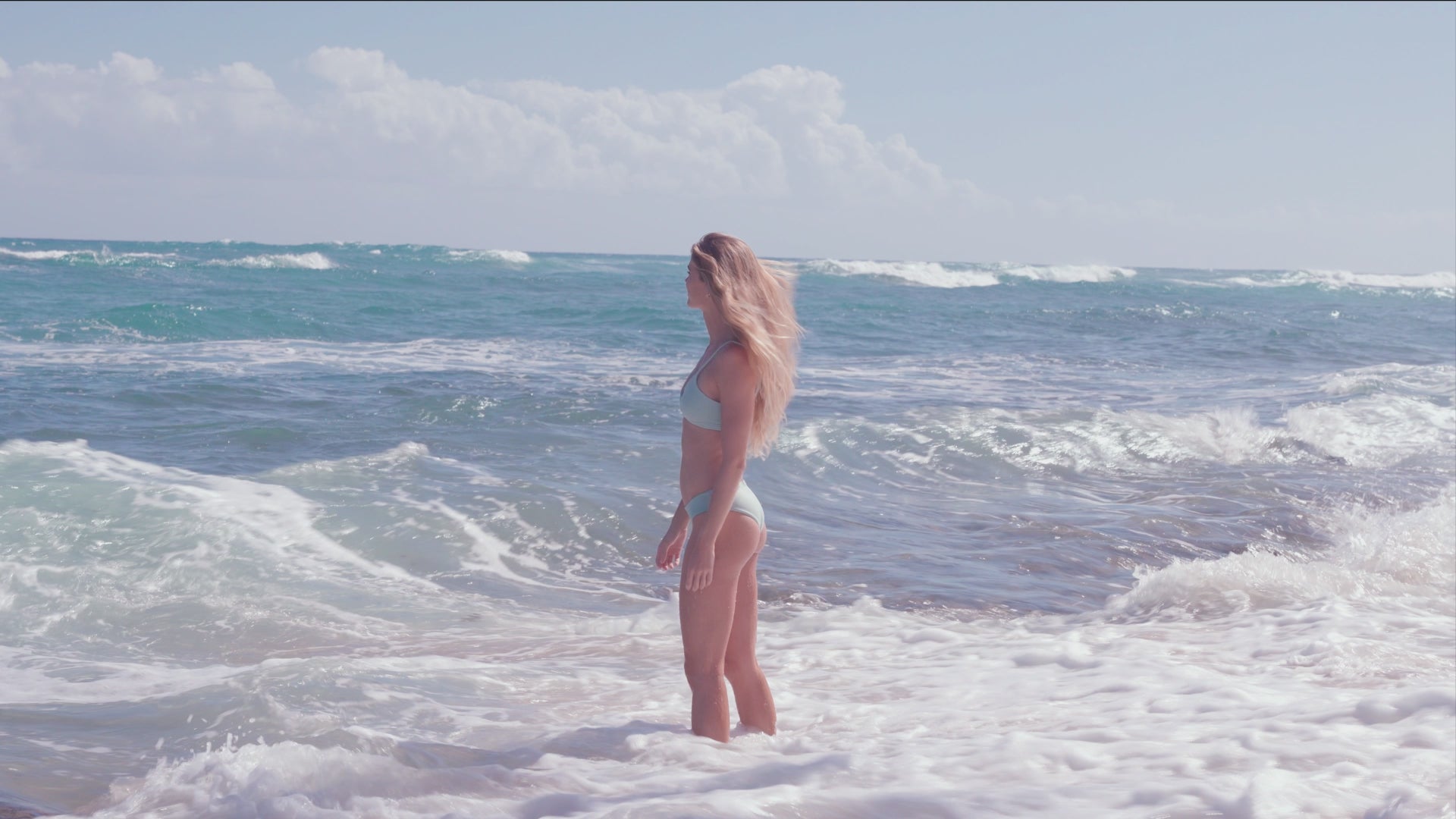 a woman playing in waves